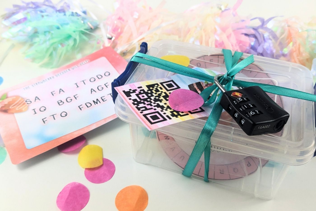 A clear plastic box with a three digit lock on it and a QR code tag attached to it.