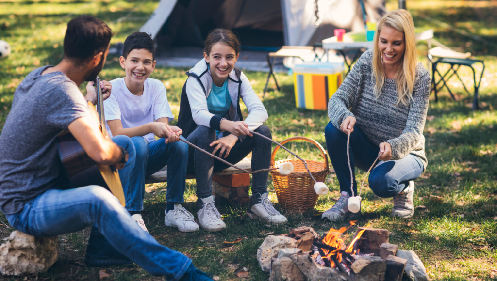 Family cooking marshmallows on a fire. Fun outdoor activities for everyone to enjoy.