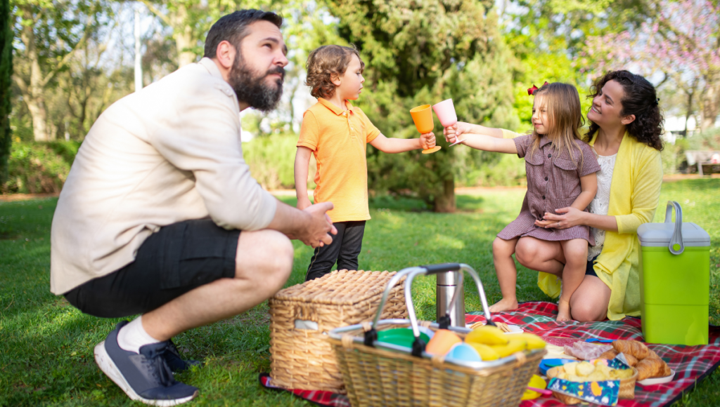 A family enjoying and outdoor picnic together.