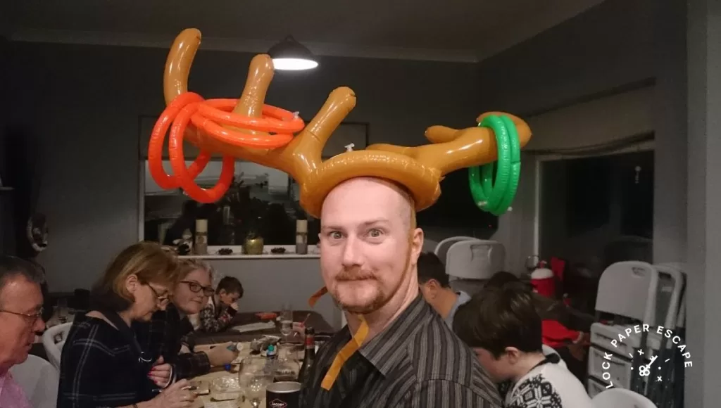 Man wearing reindeer hooplar party headband