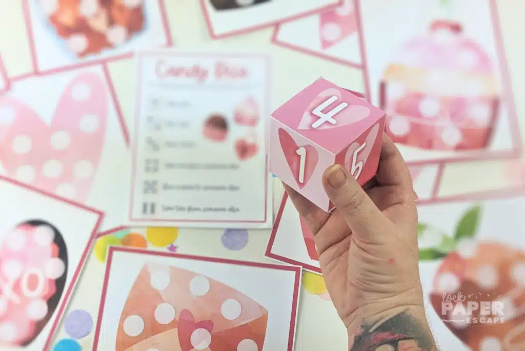 Valentine’s Day candy dice game for kids featuring printable heart-themed game boards, printable dice, and simple candy game instructions.