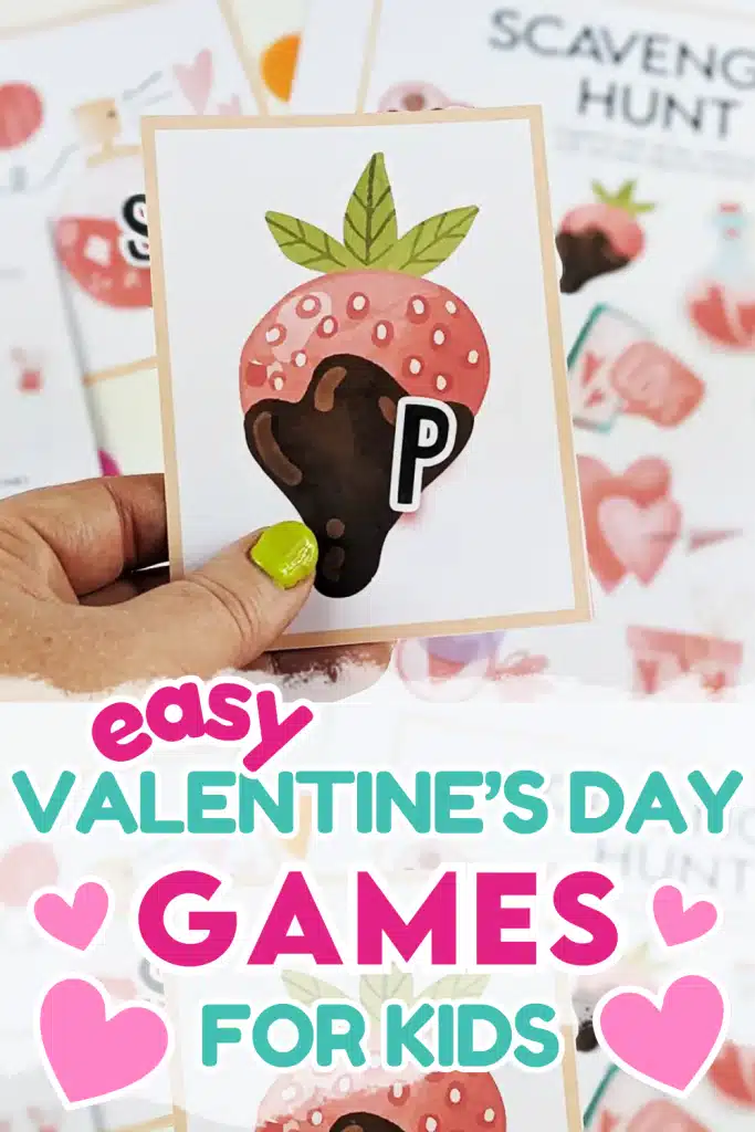 A hand holding a picture of a strawberry with the letter P on it, as part of a scavenger hunt game.