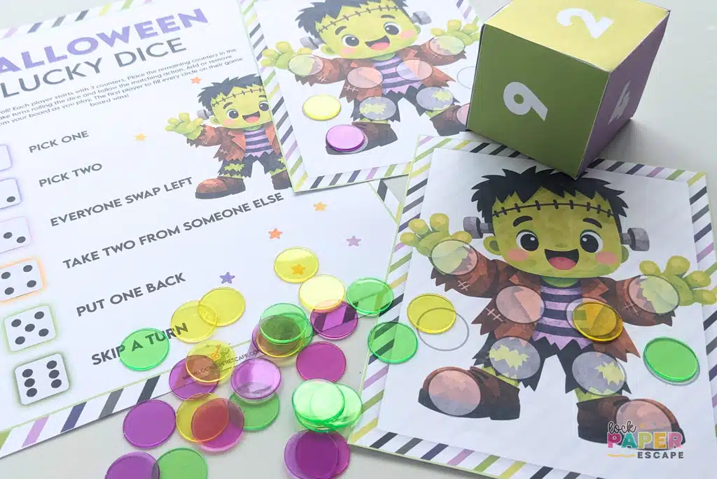 Halloween Lucky Dice printable game featuring Frankenstein game boards, a colorful paper die, game instructions, and counters ready to play.